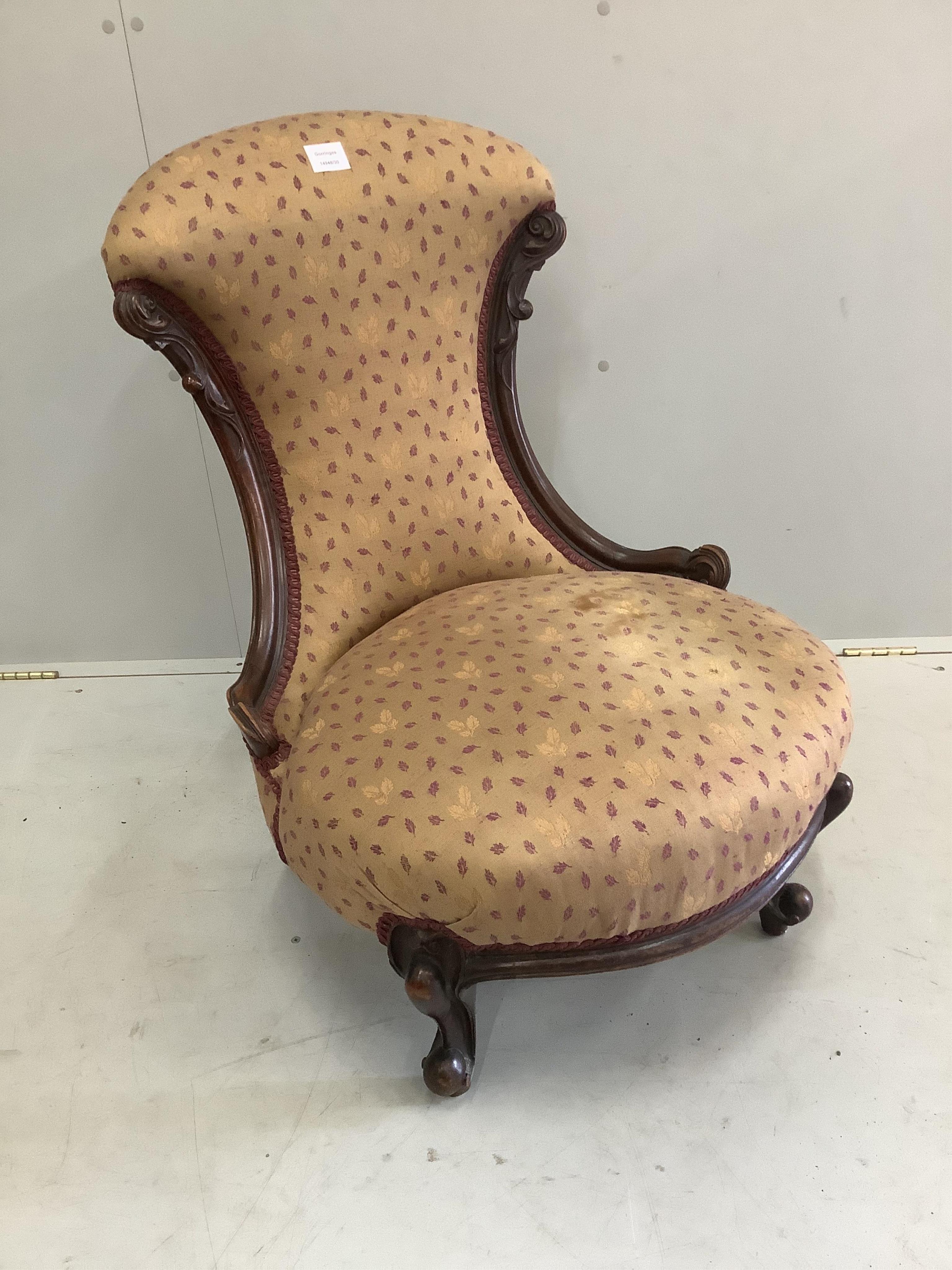 A Victorian mahogany nursing chair, width 58cm, depth 54cm, height 82cm. Condition - fair